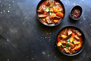 Goulash (meat stew with tomatoes and paprika) - traditional dish of hungarian cuisine.Top view with copy space.