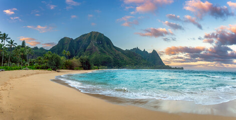 A remote deserted beach with mountains in Kauai Hawaii