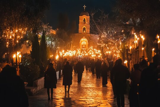 Crowd of pilgrims walking with candles during orthodox easter celebrations in front of a church in greece