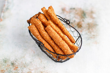 Italian grissini or salted bread sticks with sesame seeds.