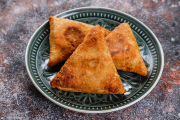 Fried samosas with vegetable filling, popular Indian snacks.