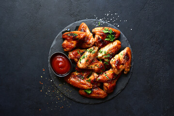 Grilled spicy chicken wings with ketchup  . Top view with copy space.