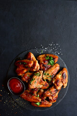 Grilled spicy chicken wings with ketchup  . Top view with copy space.