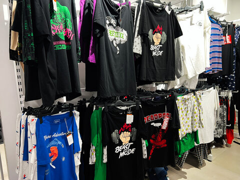 Lviv, Ukraine - February 13, 2025: Clothing display with graphic t-shirts and apparel in a retail store