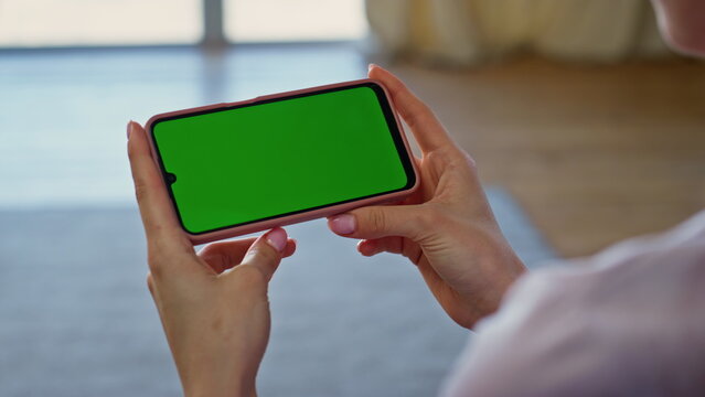 Hands holding green screen smartphone home closeup. Unknown girl looking gadget - Powered by Adobe