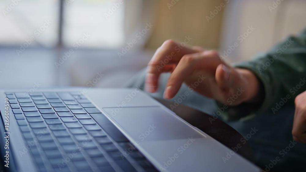 Wall mural man hands using laptop touchpad in cabinet. closeup unknown person working alone