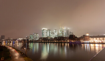 Fototapeta premium Frankfurt skyline at night across the Main river