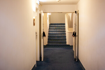 Vintage Hallway with Stairs, Interior of a hotel corridor with stairs and blue carpet, nobody inside