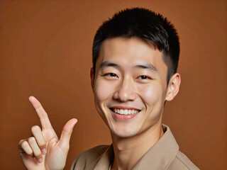 Vivid advertisement portrait photo: A man in a tan shirt making a peace sign with his fingers.