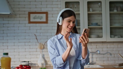 Lady using smartphone kitchen reading message cooking closeup. Joyful woman