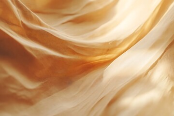 Flowing golden fabric draped elegantly, creating soft folds and waves.