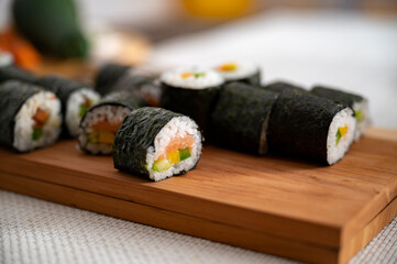 Fresh sushi rolls on a wooden board