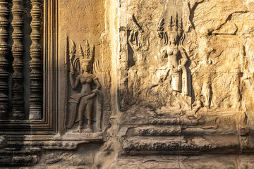Carved statues of dancing apsaras celestial nymphs on the walls of Angkor Wat, Siem Reap, Cambodia