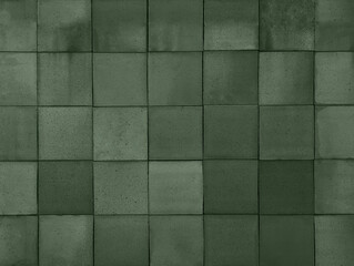 Dark moss green terracotta ceramic tiles cladding texture for interior, exterior wall, dividing wall, facade, yard, floor. Natural handmade tinted outdoor square clay slabs background.
