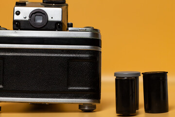 Collectible film camera, vintage analog camera and film for it, retro equipment in a metal case.
