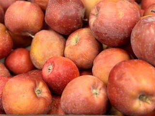 Box filled with fresh natural bio organic red apples placed on counter in local food market