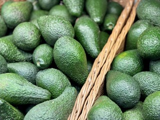 Large rifle green avocados harvested ready to eat are sold on supermarket shelves top view. Healthy eating. Close-up