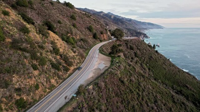 Epic Drone View of California&rsquo;s Pacific Coast Highway Winding Along Steep Cliffs and Ocean