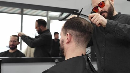Skilled barber trimming client's hair using professional scissors, creating contemporary hairstyle in modern barbershop setting with precise, professional technique