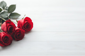 Three vibrant red roses with green leaves are elegantly arranged on white wooden surface, creating striking contrast. image exudes sense of romance and simplicity
