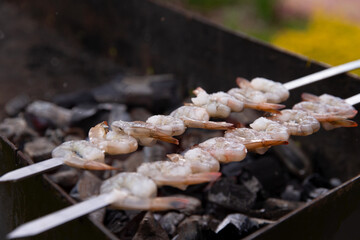 Shrimp on a skewer. Roasting on coals.