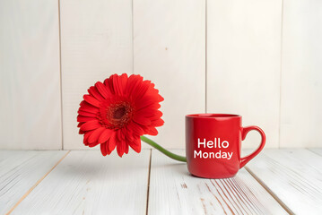 Happy monday message on red coffee mug with fresh gerbera flower on wooden table for a bright and positive start to the week with cozy morning vibes