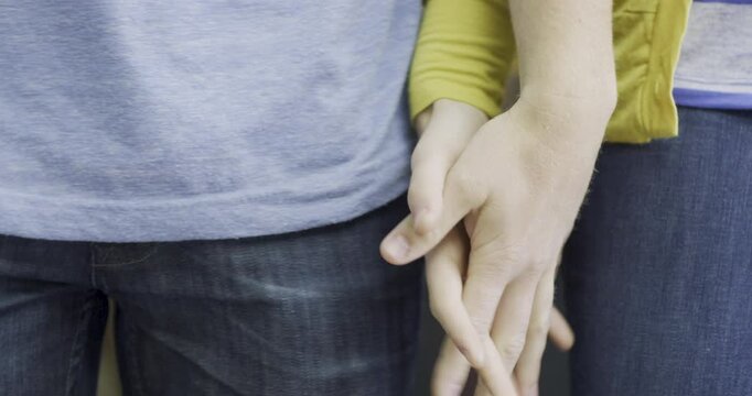 Couple interlocking fingers - closeup
