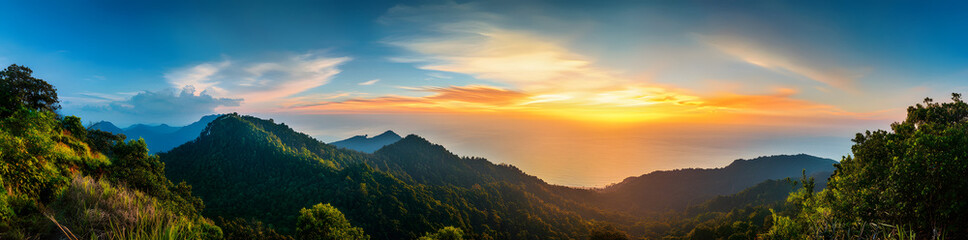 Obraz premium Panoramic view of a beautiful, colorful sunset over the sea with mountains