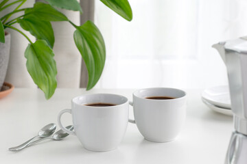 coffee cups in front of a window