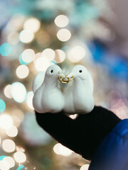 Hand Wearing Winter Glove Holding Two Christmas Turtle Gloves