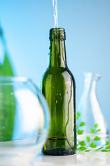 green bottle with the drops of water