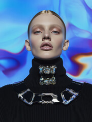 Studio portrait of a fashion model wearing a futuristic metallic choker and a dark turtleneck, posing against a vibrant, abstract background with swirling colors of blue, orange