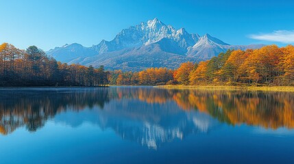 Autumn lake reflecting mountain peak, tranquil scene