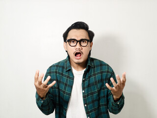 Adult Asian man screaming angry while looking forward isolated on white background