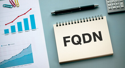 There is notebook with the word FQDN. It is an abbreviation for Fully Qualified Domain Name as eye-catching image.