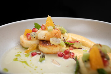 Fried cheesecakes with sauce and pieces of fruit