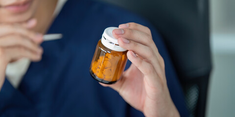 Medical student examining prescription medication in a study environment, showcasing healthcare education.