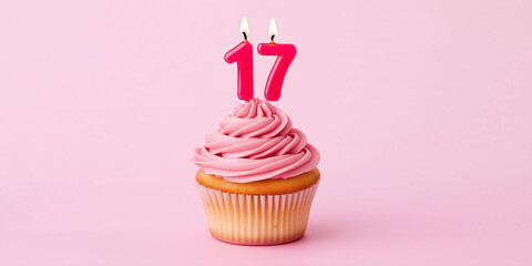 Birthday cupcake to celebrate a 17th birthday or anniversary, with candles and pink frosting
