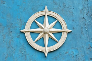Decorative compass rose is displayed on a textured blue background