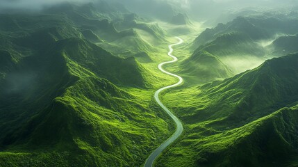 A Winding Road Through Emerald Hills: An Aerial View of Serpentine Route Cutting Through Lush Green Mountain Valleys with Soft Mist and Dreamy Light