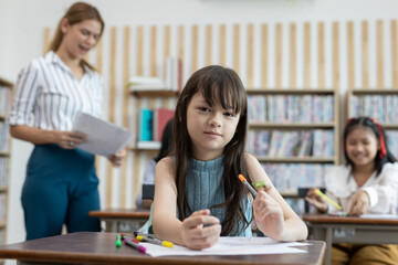 School children education in classroom. kid schoolgirl happy learning. Writing as instructed by teacher. concept of back to school.