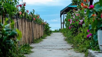 Fototapeta premium Pathway leading to a beachfront bungalow surrounded by vibrant tropical flowers and rustic bamboo fencing, bathed in natural light