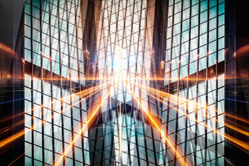 An abstract upward view of a modern glass skyscraper with dynamic orange light streaks creating a sense of motion and energy.