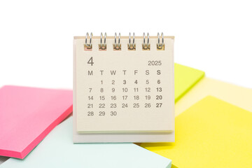 Mini Desk Calendar for APRIL 2025 background. Calendar concept with 2025 APR calendar. Sticky note....