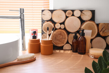Bath accessories with toothbrushes on table in room