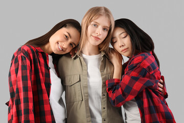 Beautiful young happy women on grey background. Women history month