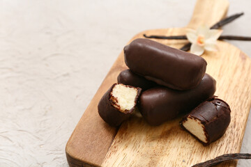 Board with curd bars and vanilla on grey grunge background, closeup