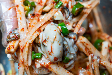 raw oysters seasoned with spicy sauces, vegetables and other ingredients