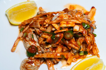 lemon, and raw oysters seasoned with spicy sauces and vegetables