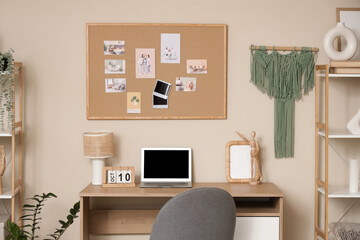 Interior of stylish living room with modern workspace and mood board
